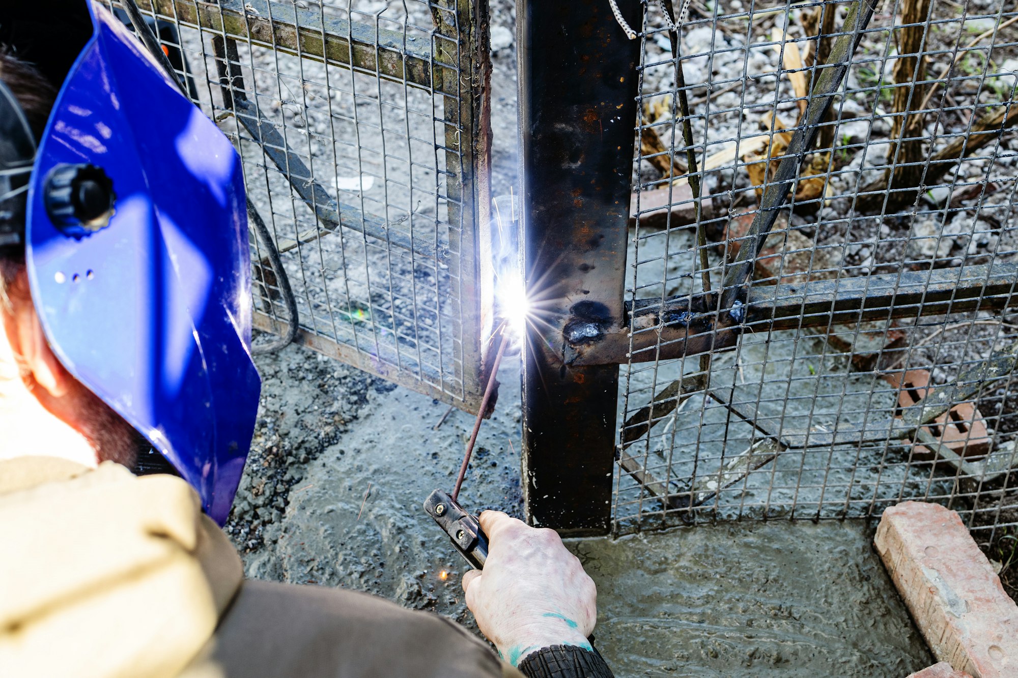 welding door hinge to freshly concreted gate post